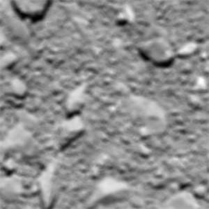Poslední fotka pořízená vesmírnou sondou Rosetta před dopadem na povrch komety 67P, kterou dva roky zkoumala. Fotka je přibližně z výšky 20 m nad povrchem, rozmazání je způsobeno pevným zaostřením kamery na snímání z výšek nad 20 km.